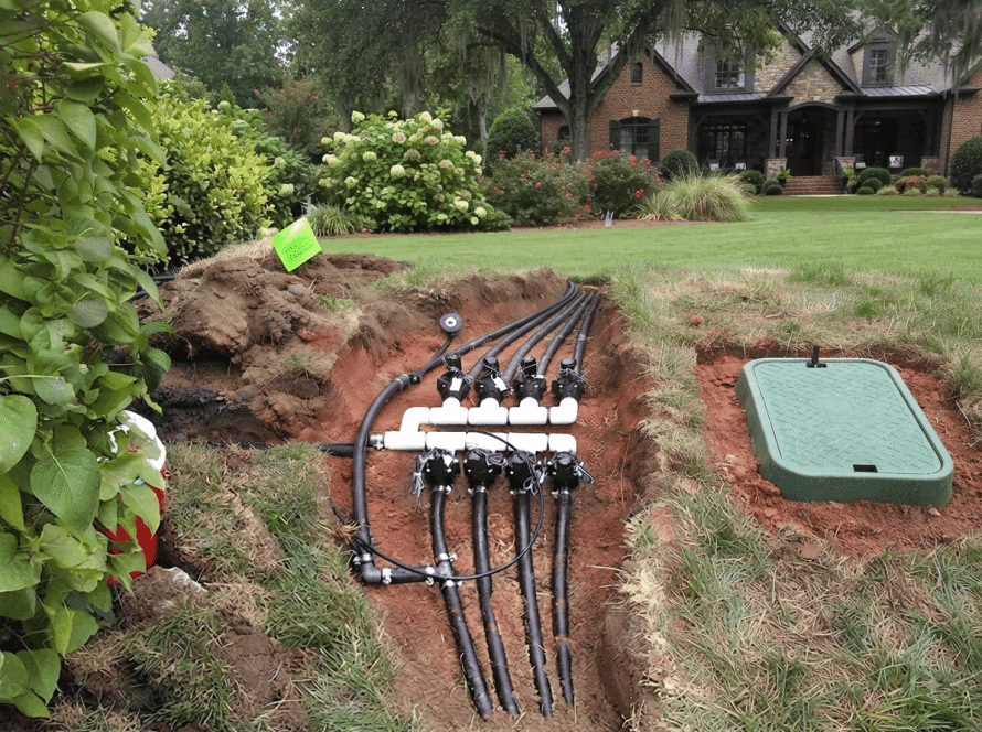 Professional irrigation technician installing a residential sprinkler system in Waxhaw NC